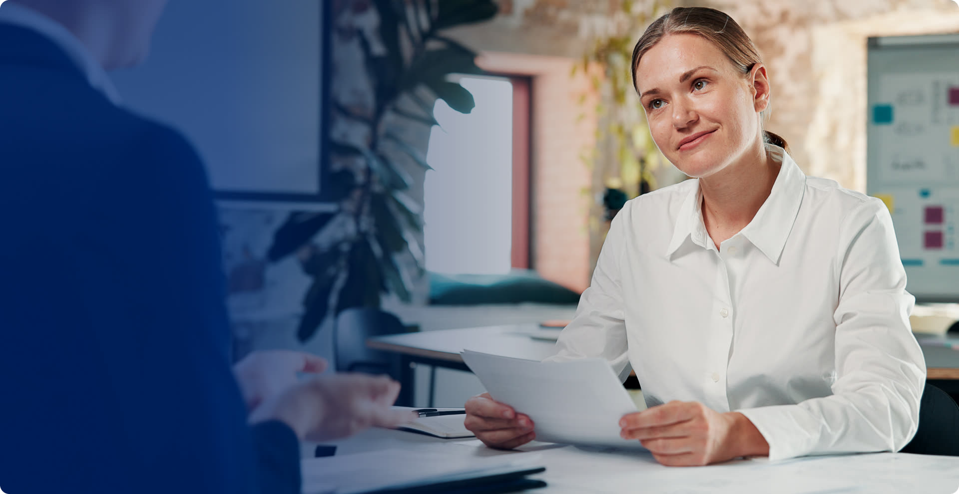 Hiring manager reviewing a candidate's documents in an interview