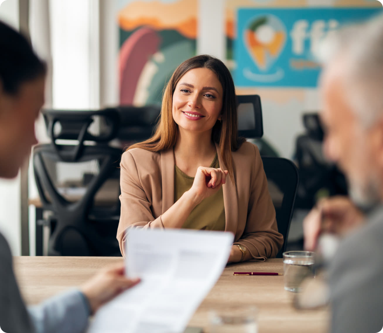 Partner-organization manager reviewing candidate documents with a colleague