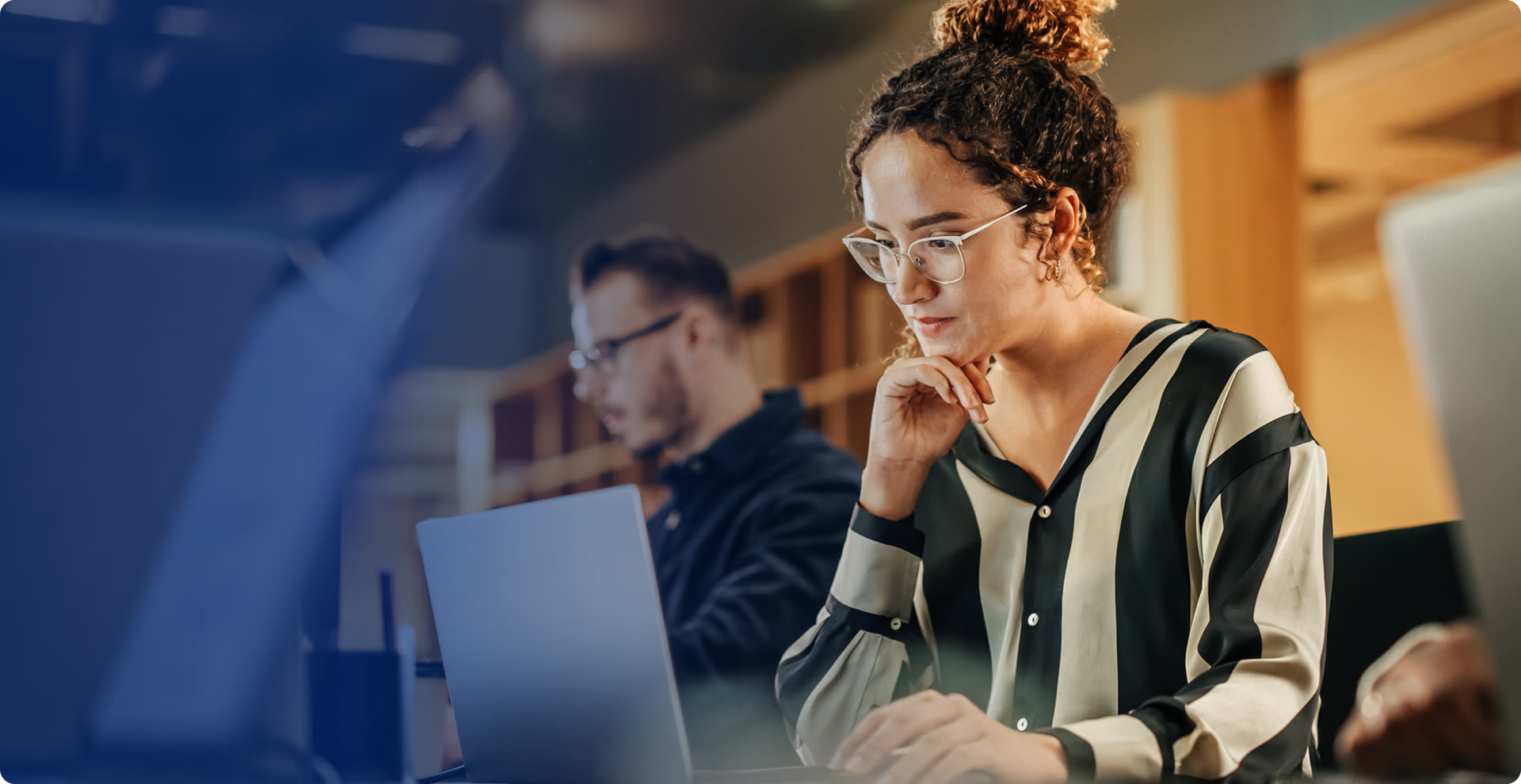 Enterprise engineer working through a live AI workflow beside a colleague