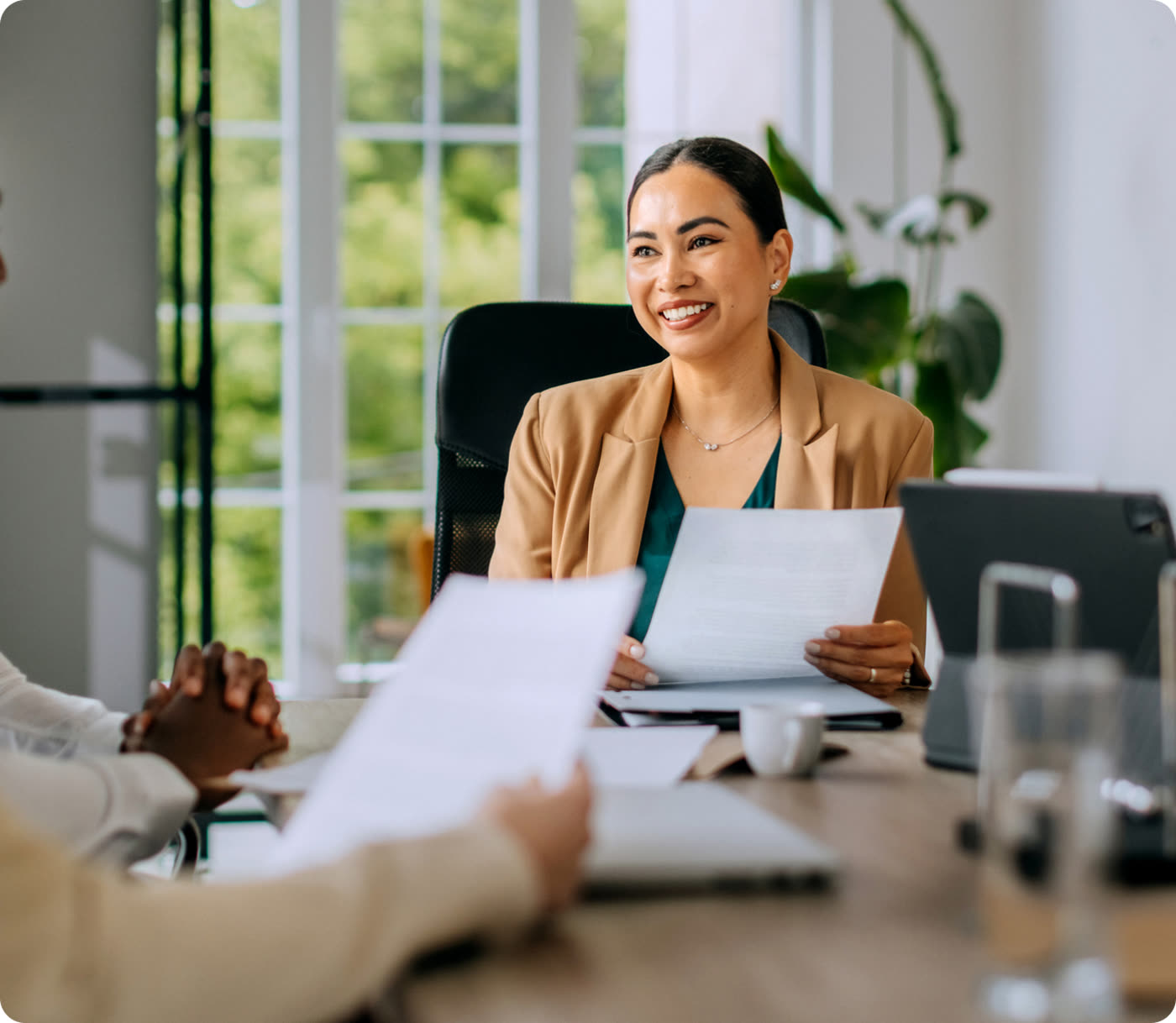 Advisor smiling while reviewing documents at a desk