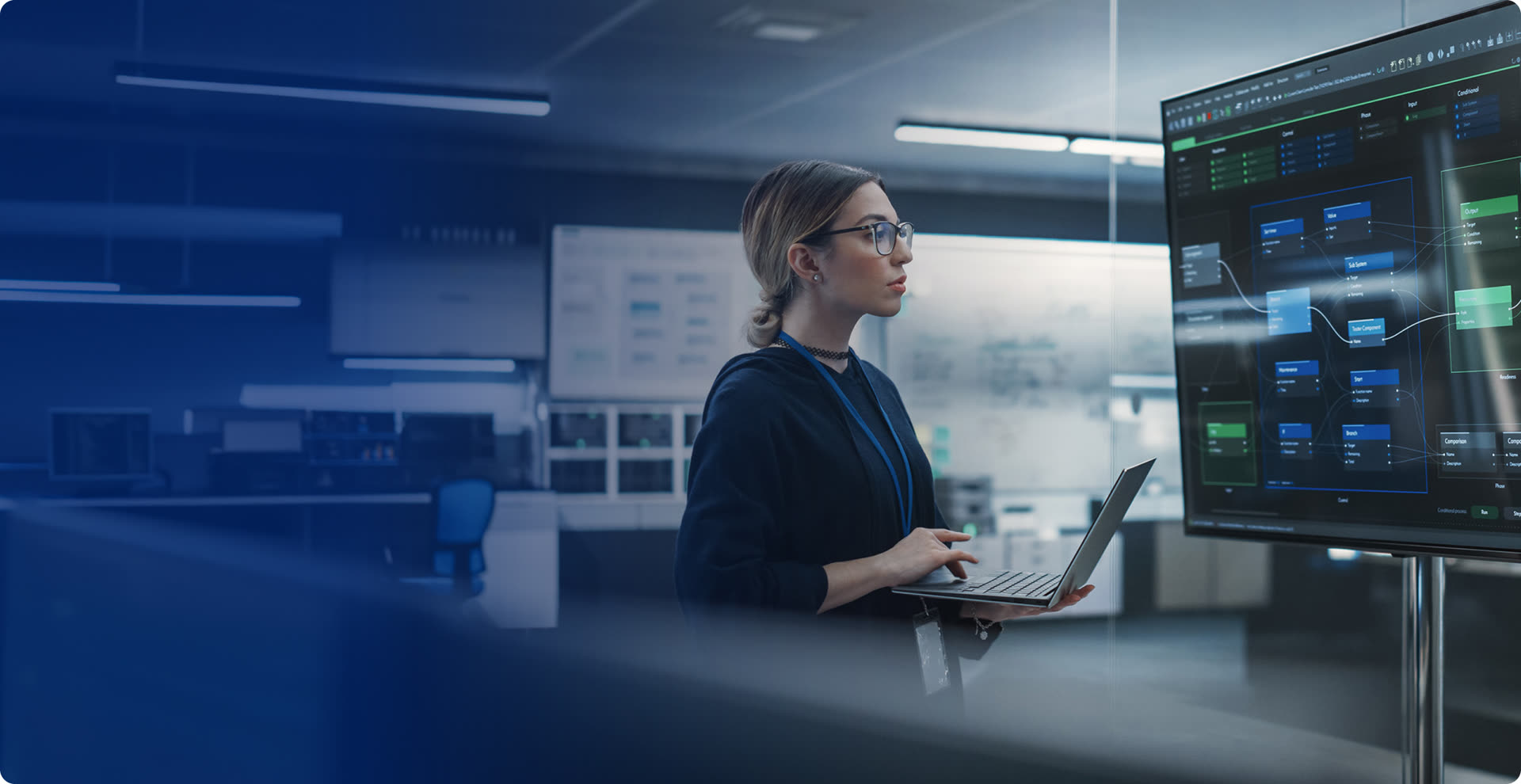 Analyst reviewing live system dashboards in a control room